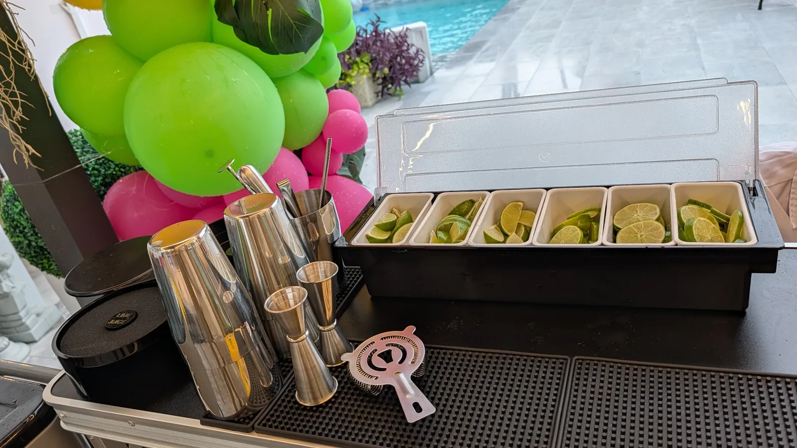 Cocktail garnish station with shakers and fresh fruit