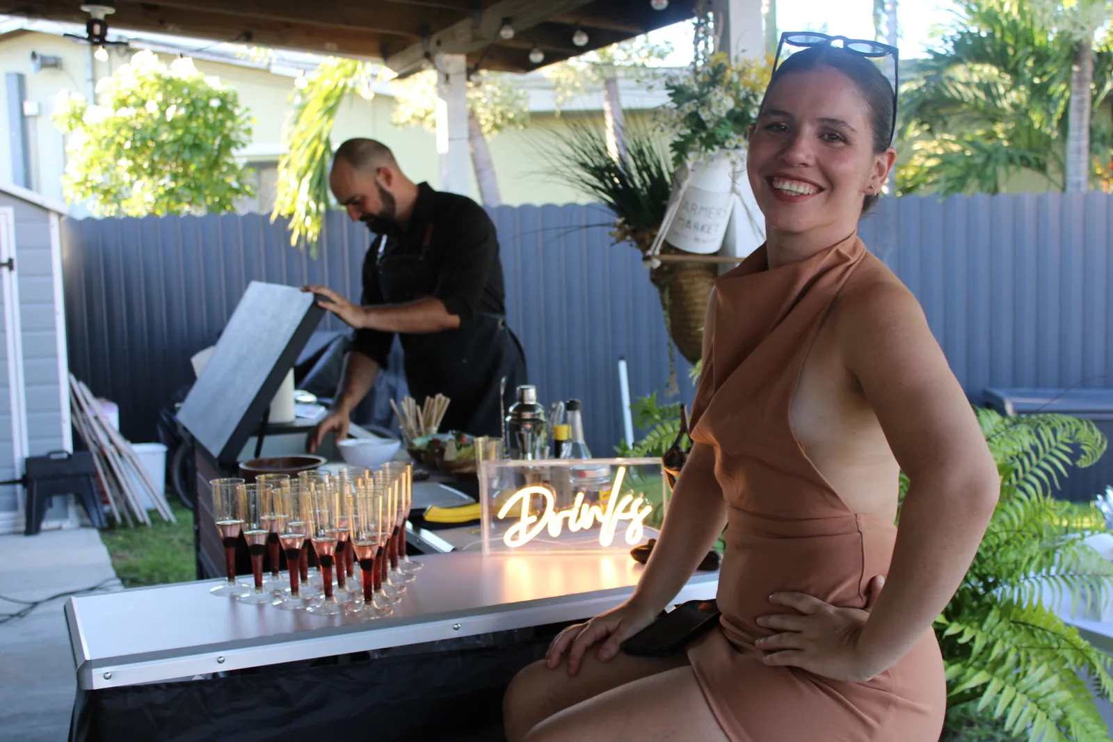 Tipsy Tides bartender serving a guest at an outdoor bar